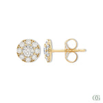 A pair of sparkling round diamond earrings with a gold-tone band and white gold mounting.